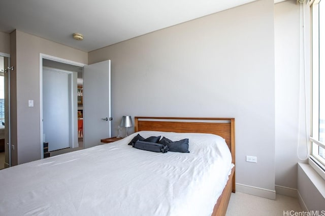 bedroom featuring light colored carpet