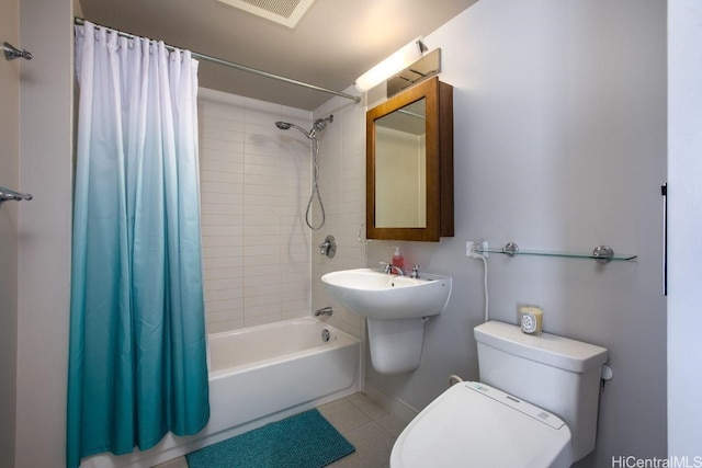 bathroom featuring shower / bath combination with curtain, toilet, and tile patterned floors