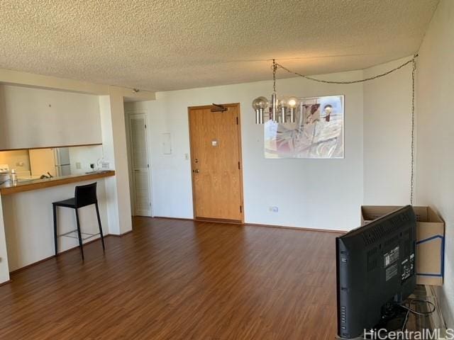 5333 Likini St Unit 2103, Honolulu, HI 96818 - dining area featuring wood finished floors, a textured ceiling, and a chandelier