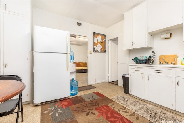 kitchen with white cabinetry and white refrigerator