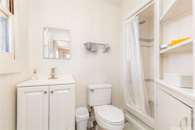 bathroom with toilet, vanity, a shower with shower curtain, and wooden walls