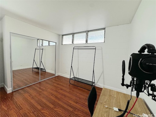 workout area with wood finished floors and baseboards