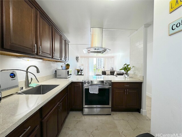 kitchen with dark brown cabinetry, island range hood, a sink, light countertops, and stainless steel range with electric stovetop