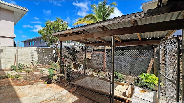 view of patio featuring fence and an outbuilding