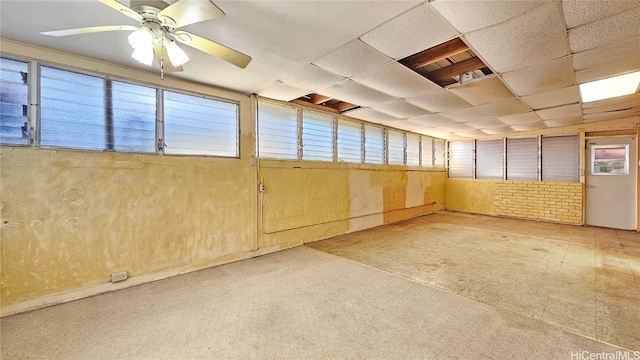 interior space featuring a paneled ceiling and ceiling fan