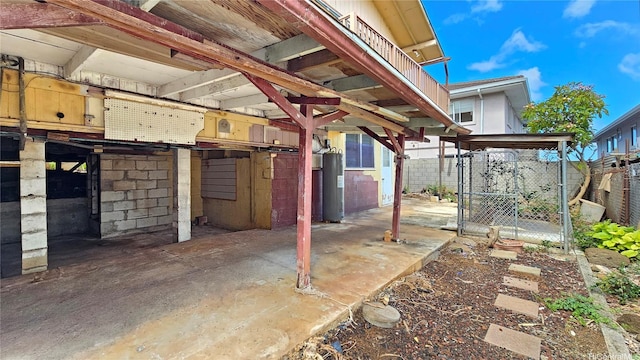 view of patio / terrace with fence and electric water heater