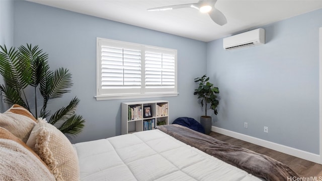 bedroom featuring ceiling fan, wood-type flooring, and a wall mounted air conditioner