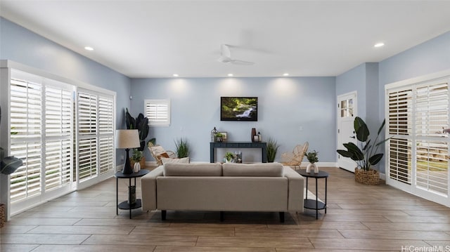 living room featuring dark wood-type flooring and ceiling fan