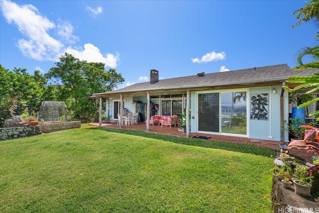 back of property featuring a yard and a patio