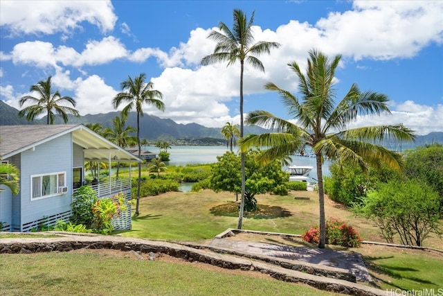 view of home's community with a yard and a water and mountain view