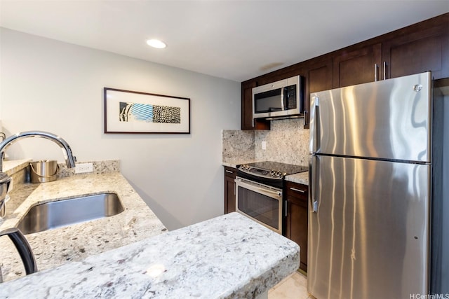 1777 Ala Moana Blvd Unit 207, Honolulu, HI 96815 - kitchen featuring appliances with stainless steel finishes, dark brown cabinetry, light stone counters, backsplash, and recessed lighting