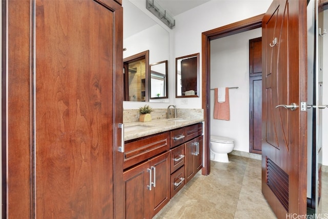 bathroom with toilet and vanity