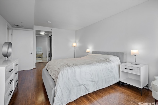 bedroom with dark hardwood / wood-style flooring