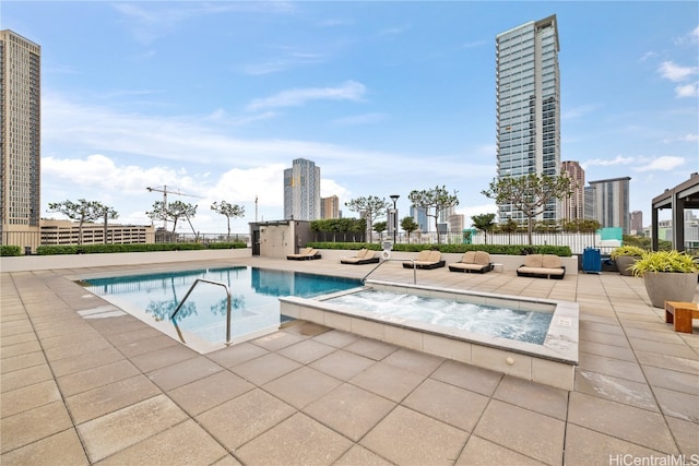 view of swimming pool with an in ground hot tub and a patio area