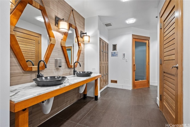 bathroom with decorative backsplash and sink