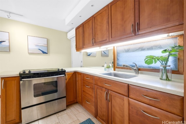 kitchen with light tile patterned flooring, stainless steel range oven, and sink