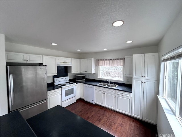 kitchen with sink, dark hardwood / wood-style floors, a textured ceiling, appliances with stainless steel finishes, and white cabinetry