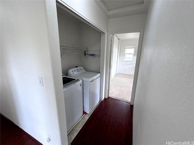 clothes washing area featuring washer and dryer and light hardwood / wood-style floors