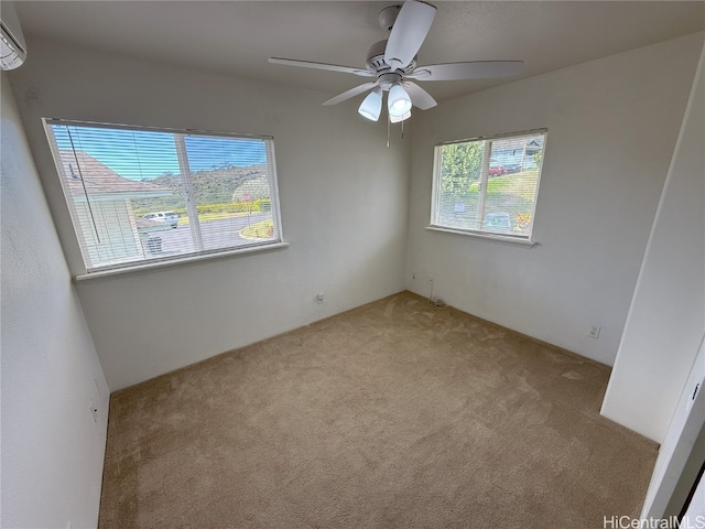 carpeted spare room with ceiling fan