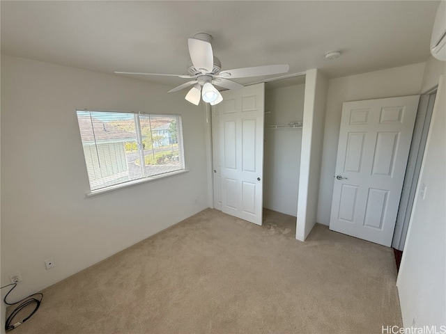 unfurnished bedroom with ceiling fan, a closet, and light colored carpet