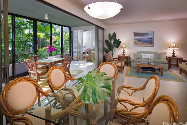 tiled dining area with ornamental molding, a wealth of natural light, and a wall of windows