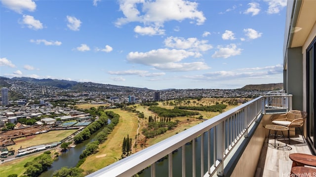 balcony featuring a water and mountain view