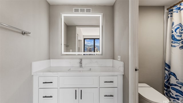 bathroom featuring vanity and toilet