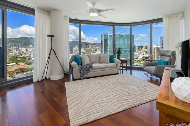 living room with plenty of natural light, dark hardwood / wood-style floors, and floor to ceiling windows