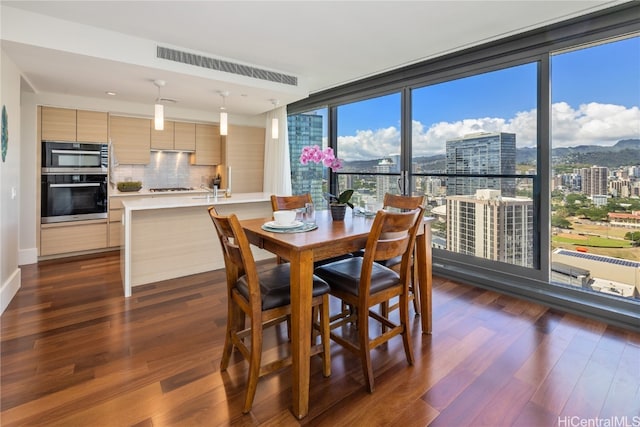 dining area with dark wood-type flooring