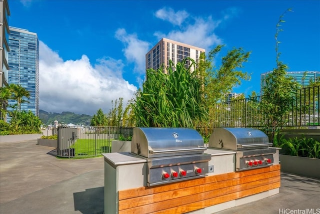 view of patio with area for grilling and a mountain view