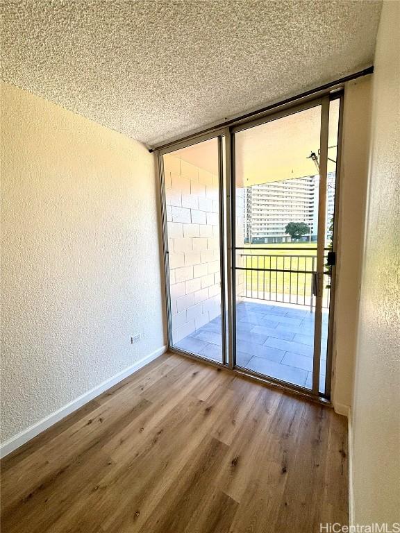 entryway featuring hardwood / wood-style flooring, a healthy amount of sunlight, and a textured ceiling