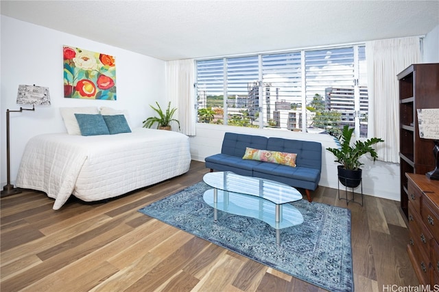 bedroom featuring a textured ceiling and wood-type flooring