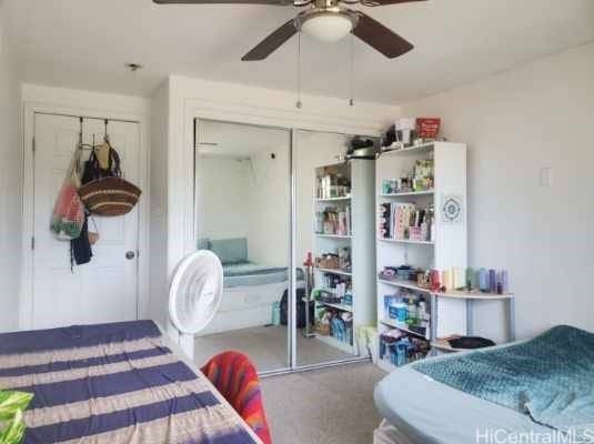bedroom featuring carpet, ceiling fan, and a closet