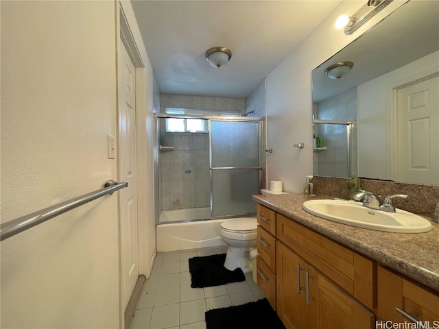 full bathroom with vanity, enclosed tub / shower combo, toilet, and tile patterned flooring