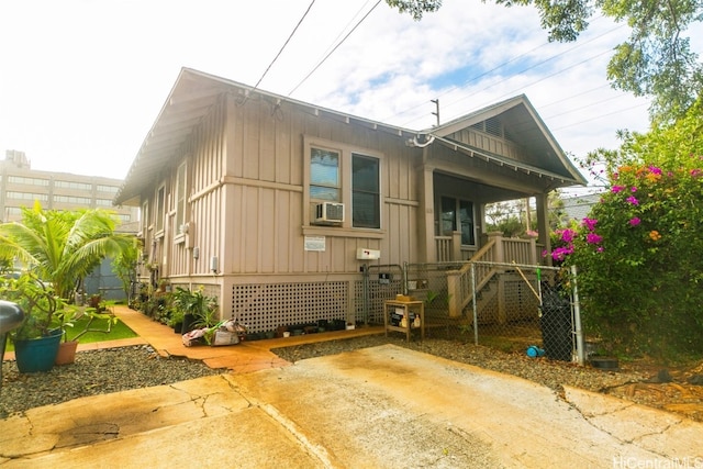 exterior space with a porch and cooling unit