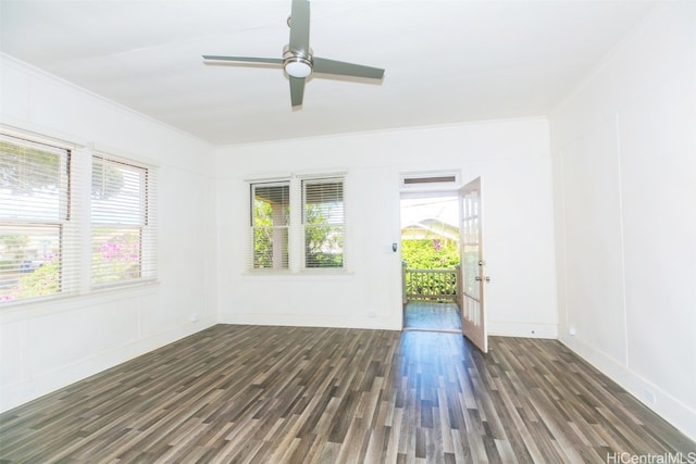 spare room with crown molding, ceiling fan, a wealth of natural light, and dark hardwood / wood-style flooring