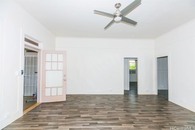 empty room with ornamental molding, ceiling fan, and dark hardwood / wood-style flooring