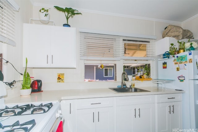 kitchen with white cabinetry, crown molding, sink, and white appliances