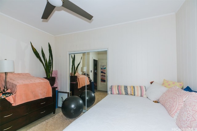 bedroom with ceiling fan, crown molding, wooden walls, and light colored carpet