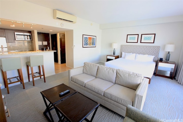 bedroom with white fridge and a wall unit AC