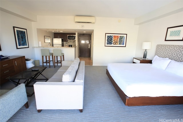 carpeted bedroom with a wall mounted AC and white refrigerator