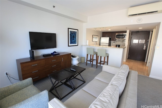 tiled living room featuring track lighting and a wall unit AC