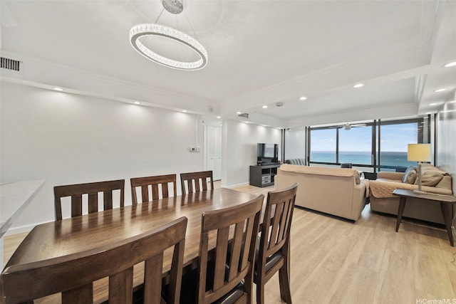1600 Ala Moana Blvd Unit 3702, Honolulu, HI 96815 - dining room with crown molding, light wood-type flooring, a tray ceiling, visible vents, and recessed lighting