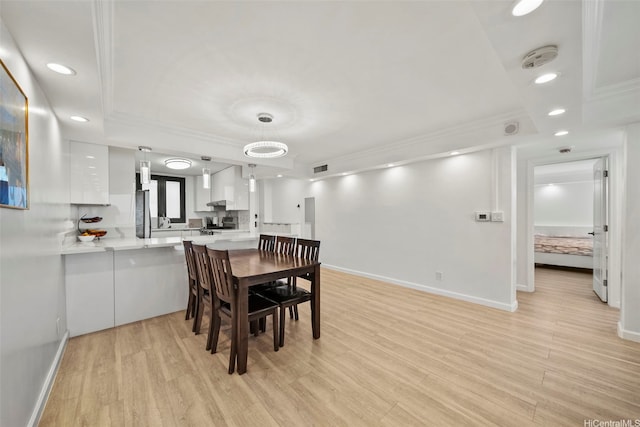 1600 Ala Moana Blvd Unit 3702, Honolulu, HI 96815 - dining space with a tray ceiling, light wood-style floors, and ornamental molding