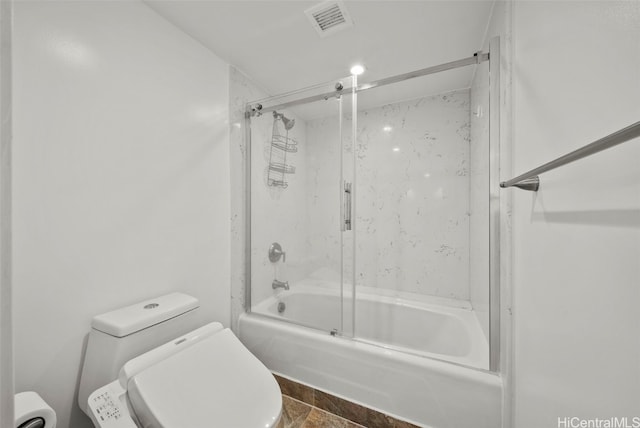 bathroom with toilet and enclosed tub / shower combo