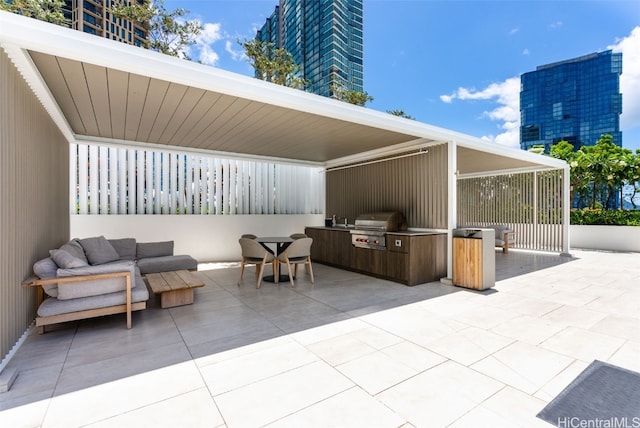 view of patio / terrace featuring a grill and an outdoor kitchen