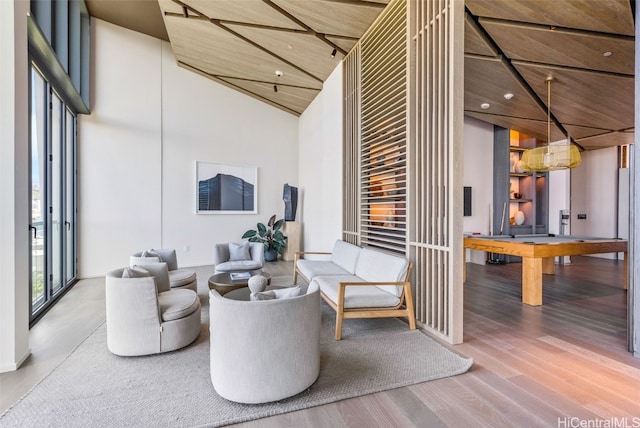 interior space with high vaulted ceiling and hardwood / wood-style floors