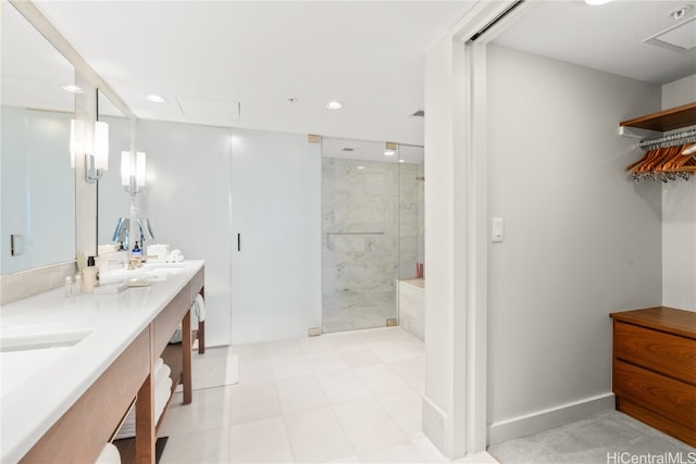 bathroom featuring a shower with door and vanity