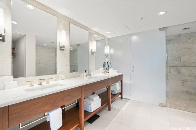 bathroom with vanity, tile walls, and a shower with door