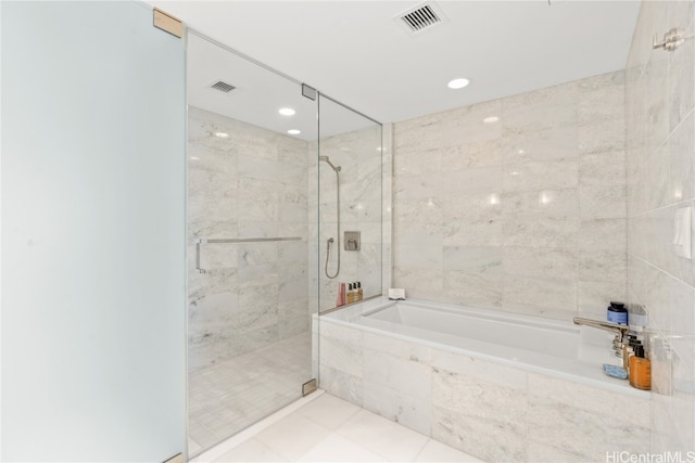 bathroom with independent shower and bath and tile patterned flooring